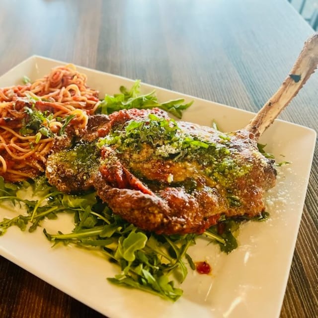 BONE-IN VEAL CHOP PARMIGIANA.